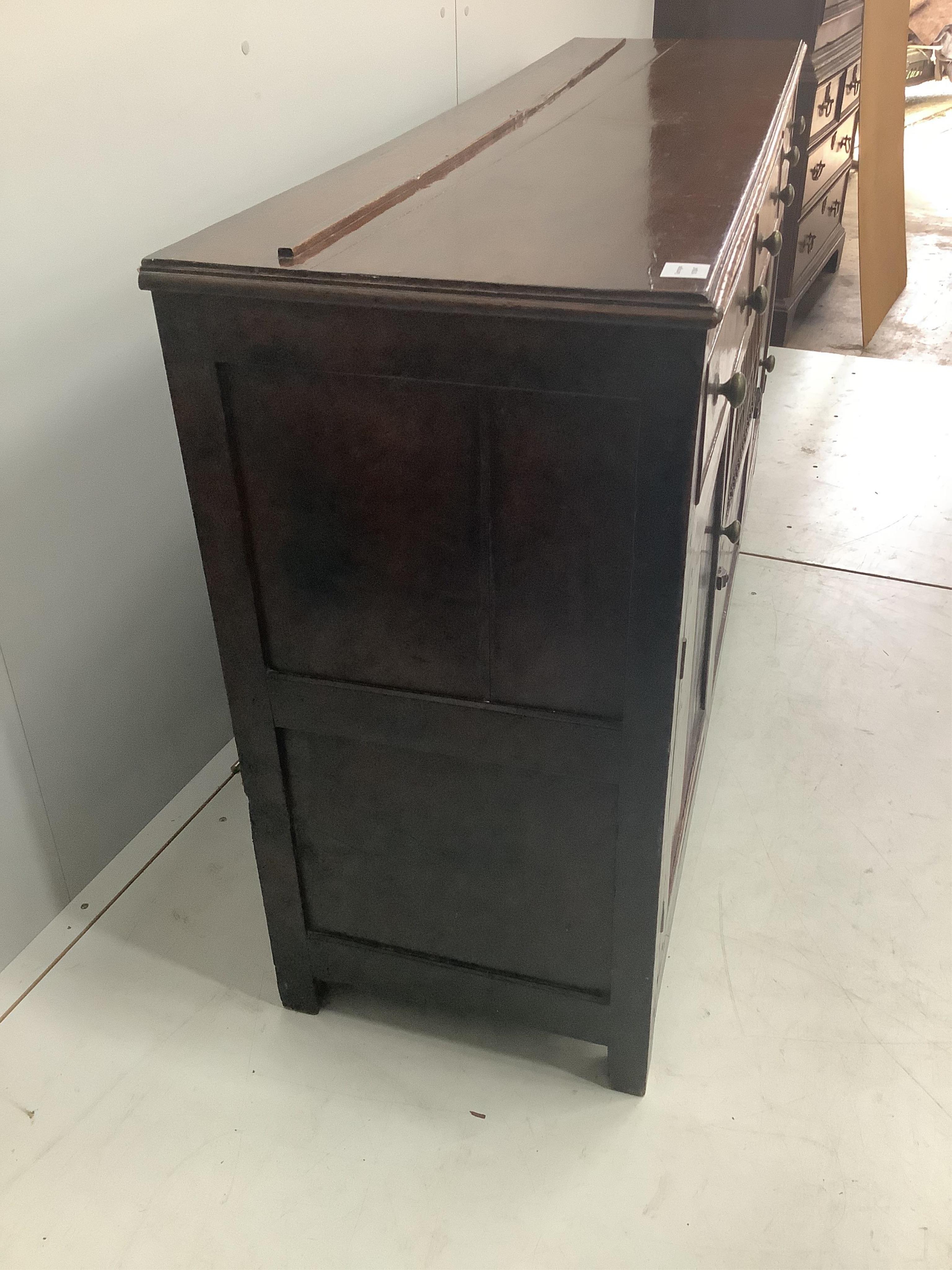 An 18th century North Wales oak enclosed dresser with central spindled glass or food compartment, width 163cm, depth 43cm, height 84cm. Condition - light wear but essentially good. Purchased from the specialist oak deale